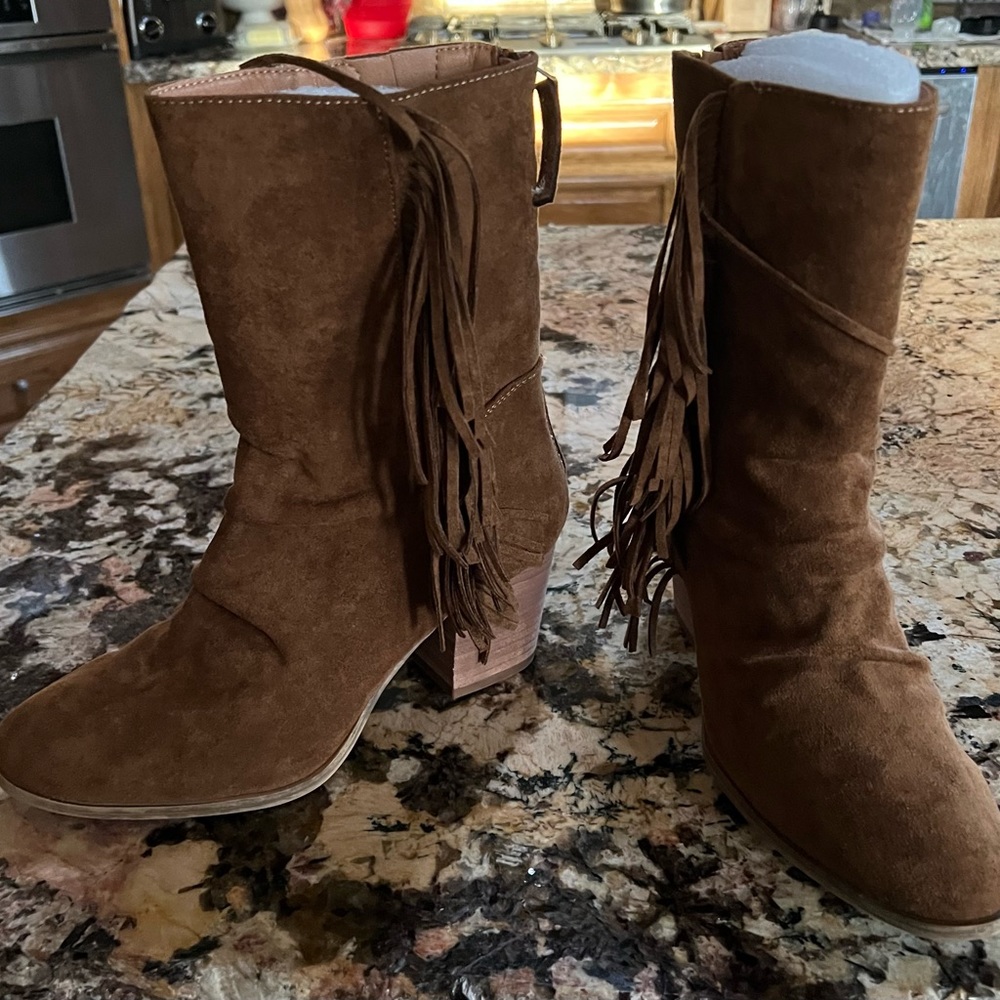 Cute boots with fringe and zipper down the back.  Brand new.